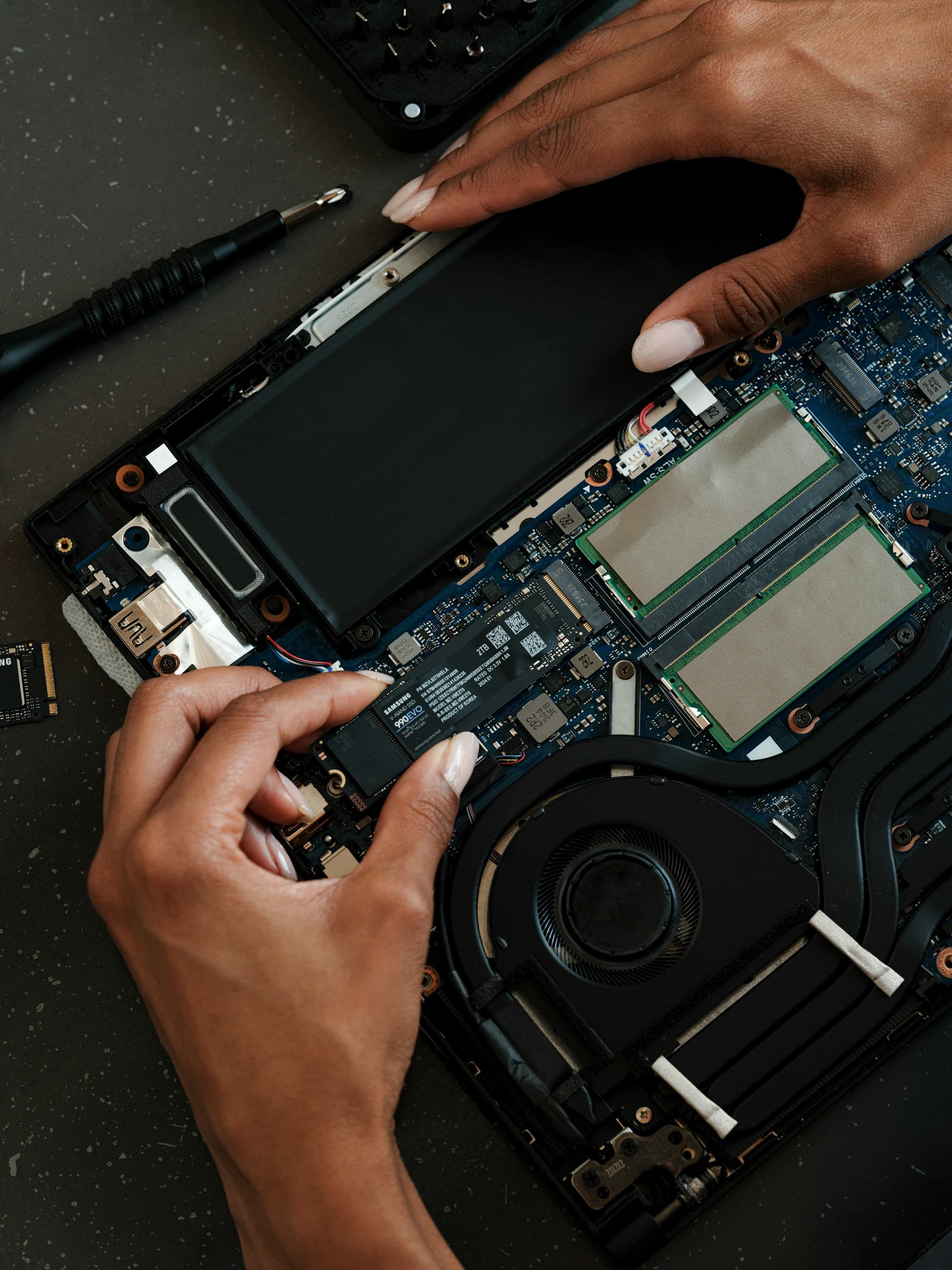Technician installing storage inside a laptop